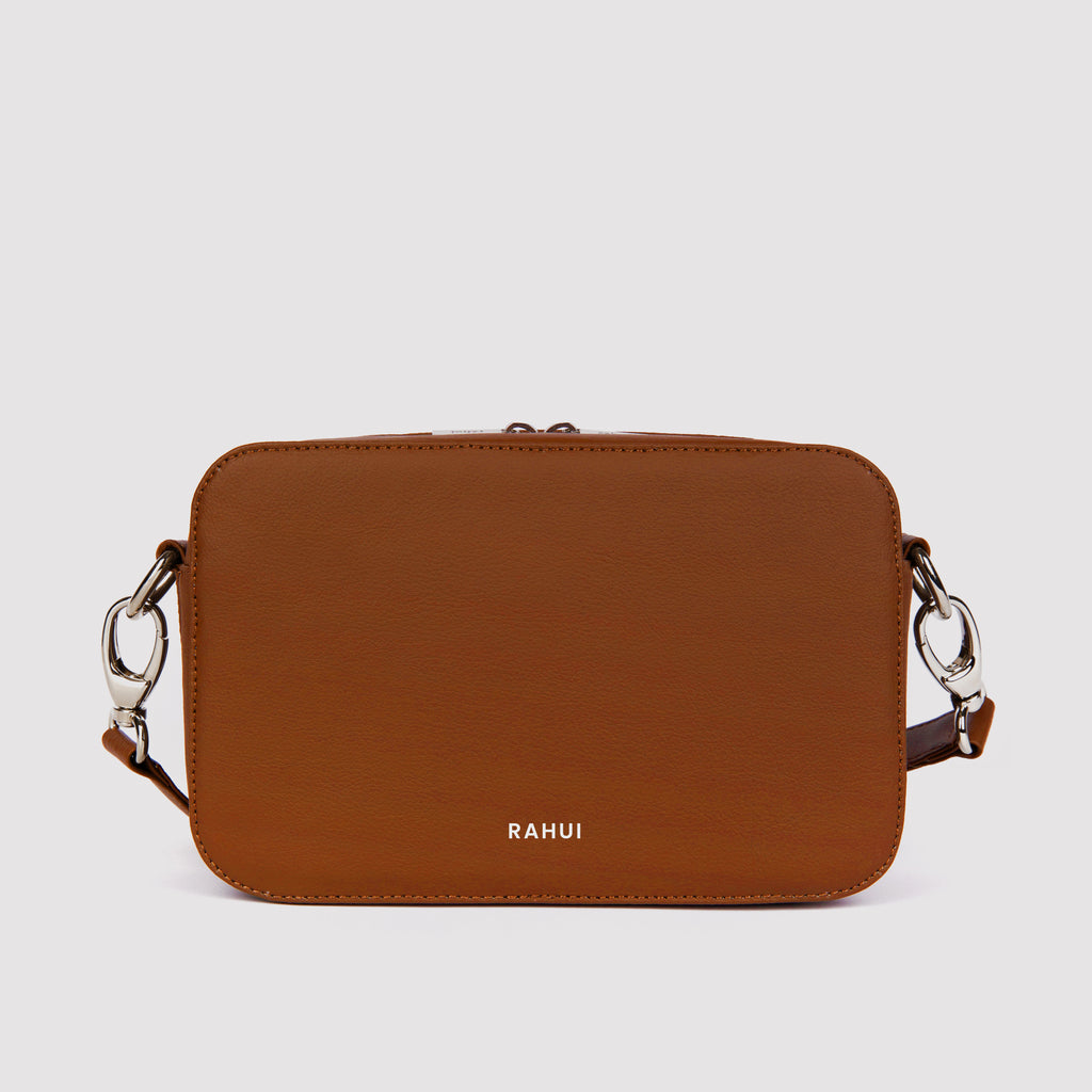 Front view of tan Rahui Crossbody bag made from apple leather on white background