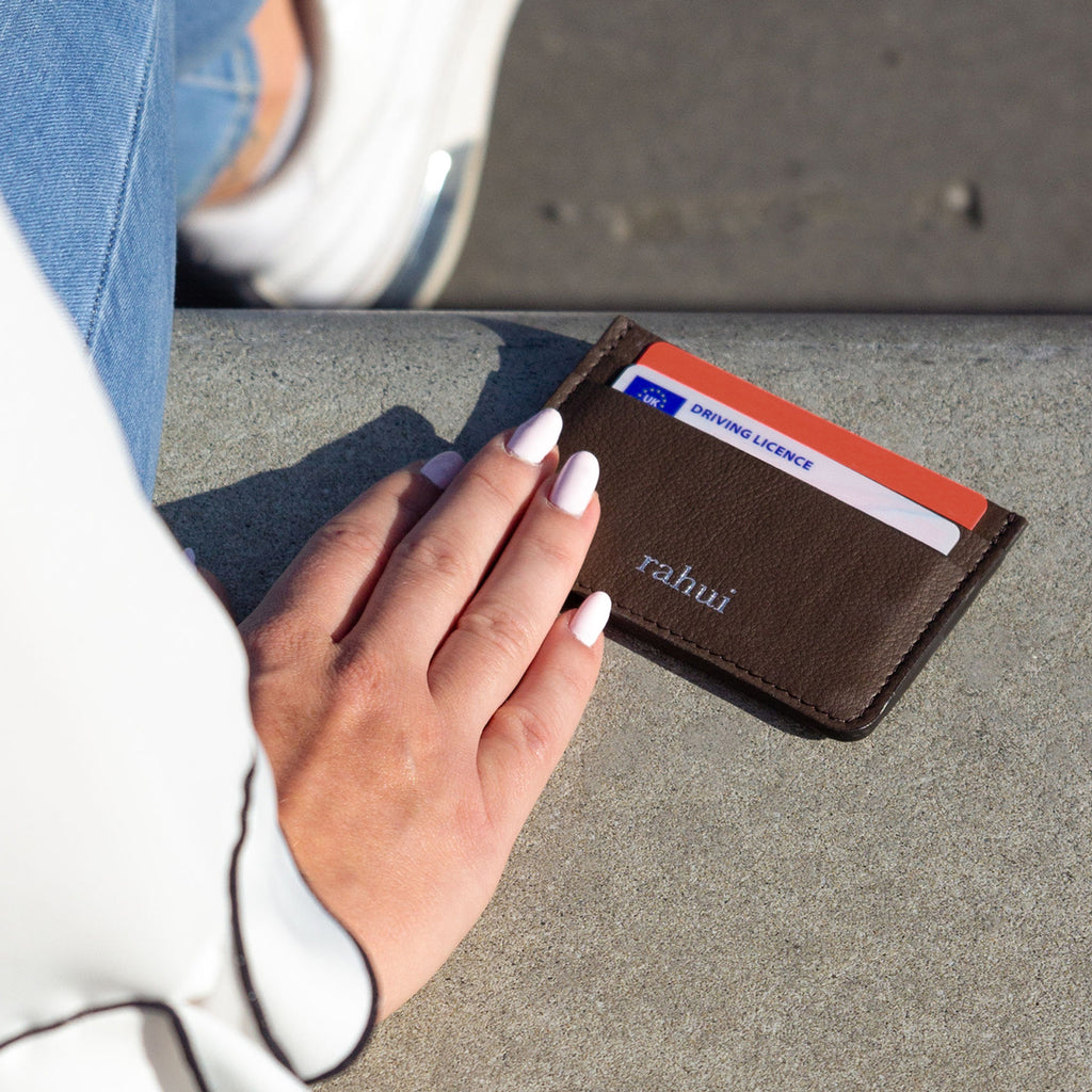 Brown Rahui Juniper card wallet with credit cards on a wall