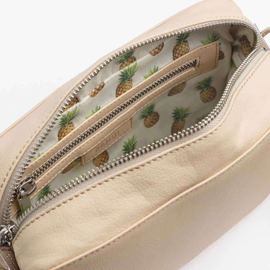 Inside view of natural Rahui Crossbody bag made from apple leather on white background