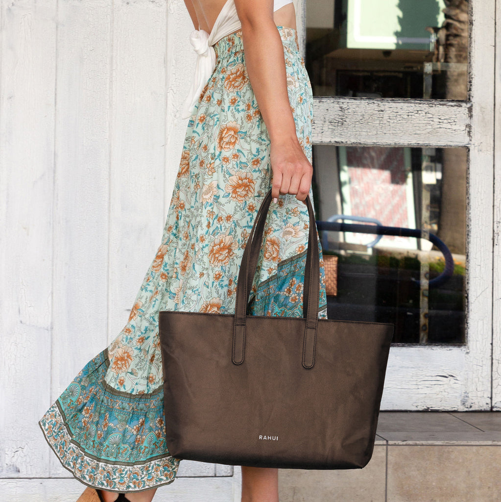 Sequoia Zip Tote held by woman walking | Brown Pinatex Performance Pineapple Classic Collection Rahui London