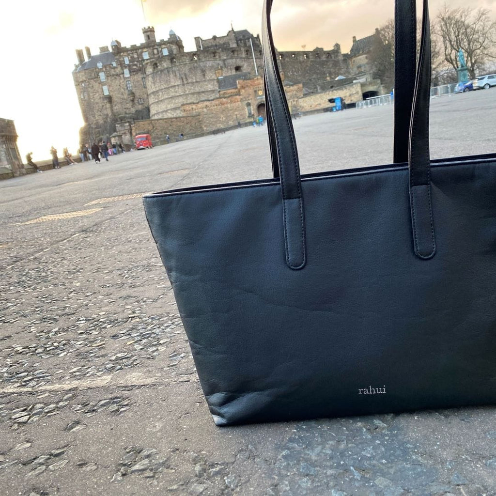 Rahui Sequoia Zip Tote sitting on the ground in front of Edinburgh castle 